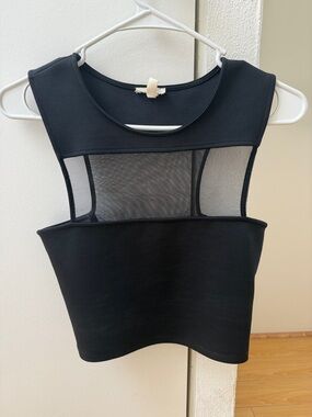 Black mesh going out top. Says a size M but honestly more XS/S